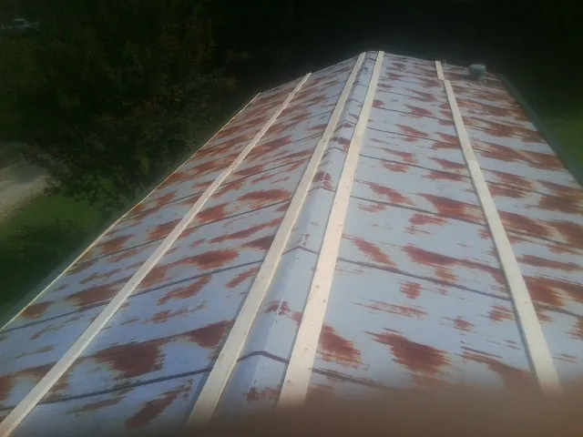 Rusted metal roof panels with new wood purlins before replacement — Storm Damage Roof Repair in Lyndhurst by Roofing Brothers